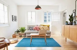 A bright living room with pendant lighting in a finished home